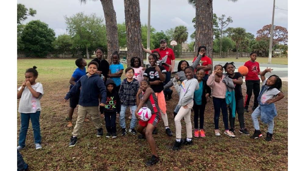 Florida firestone complete auto care employee with boys and girls club kids
